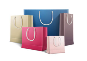 Colored shopping paper bags with rope handle, eco-friendly packaging solution, exporter from India.